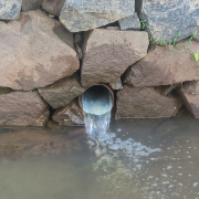 a large pipe is coming out of the water