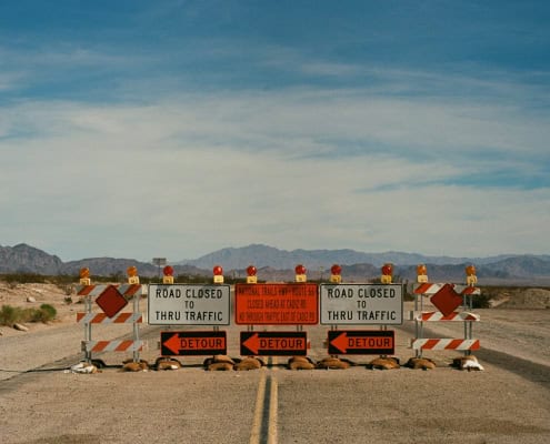 a couple of road signs sitting on the side of a road