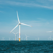 a group of wind turbines in the ocean