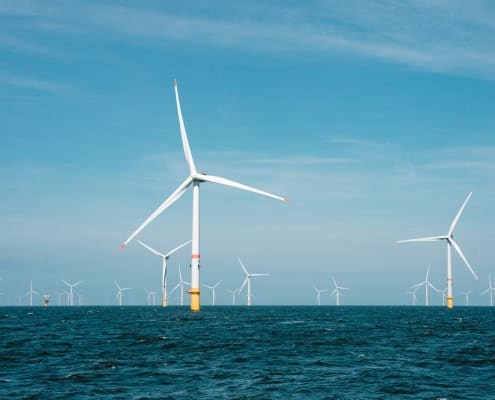 a group of wind turbines in the ocean