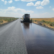 a large truck driving down a wet road